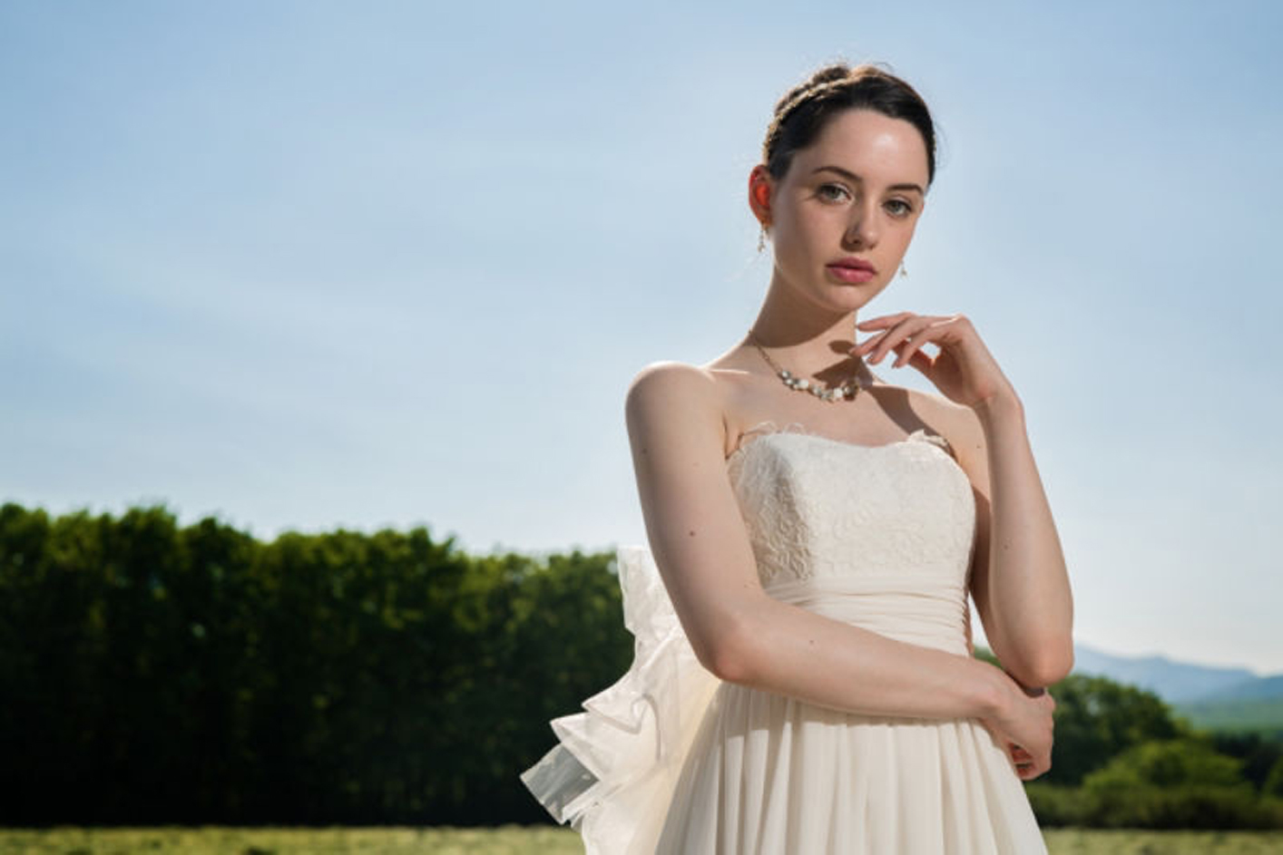 Example image of a woman wearing a white dress with a forest in the background