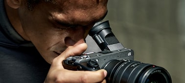 Usage image of a videographer looking through an electronic viewfinder tilted at a 45-degree angle