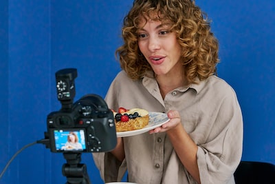 Usage image showing a user live streaming with the camera mounted on a tripod