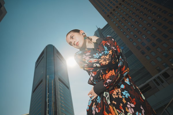 Image of a woman posing with a building in the background