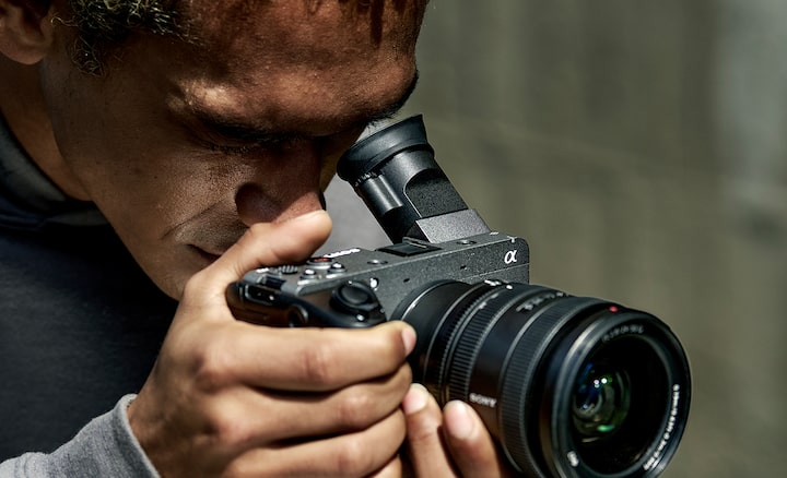 Usage image of a videographer looking through an electronic viewfinder tilted at a 45-degree angle