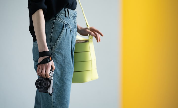 Image of person standing, holding camera