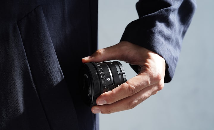 Image of person taking out lens from pocket