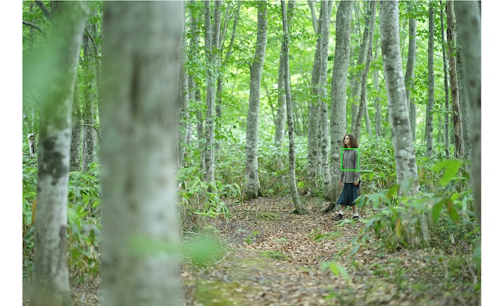Image of a woman walking in the woods